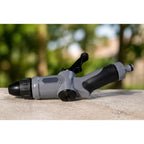 Black Grey Water Spray Gun Nozzle with a blurr natural background